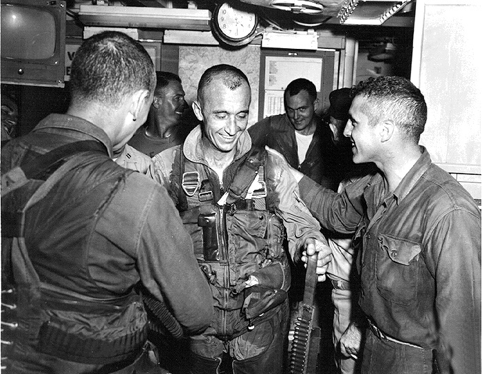 left to right: Lt Bill Nelson, Maintenance Officer, CDR Hal Marr, LCDR Kay Russel, and LCDR Cole Black      CDR Hal Marr being congratulated in the ready room   aboard USS Hancock (CVA-19) after his MiG shootdown.              12 June 1966