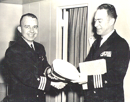 CDR R. F. Bennie, USN, being congratulated by CAPT Fitzpatrick, USN, upon being promoted to Commander aboard USS Wright (CVL-49) sometime middle 1960s