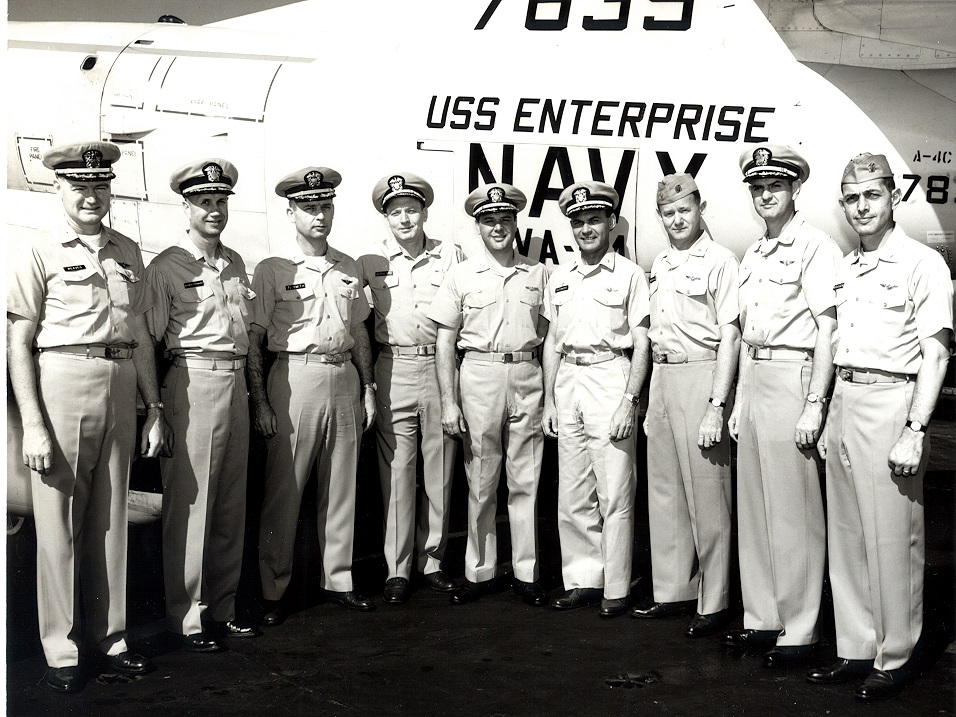 Past and present COs of A-4 Squadrons aboard USS Enterprise (CVAN-65)       left to right:	unknown; CDR Robert E. Schwoeffermann, Ship’s navigator; CDR James V. Smith, Air Officer; unknown; CAPT James Holloway, III, CO USS Enterprise; CDR James Sizemore, CO VA-45; John Marshall, CO VA-36; CDR James Linder, CO VA-76; and CDR Otto Krueger, CO VA-94.    1966